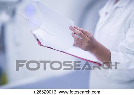 Hospital radiologist checking notes View Large Photo Image Stock Image - Hospital radiologist checking notes. Fotosearch