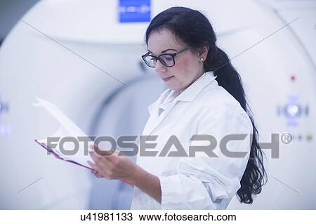 Stock Image - Hospital radiologist checking notes. Fotosearch