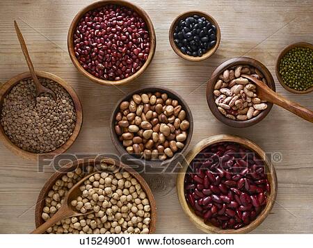 Stock Image - Pulses in wooden bowls. Fotosearch