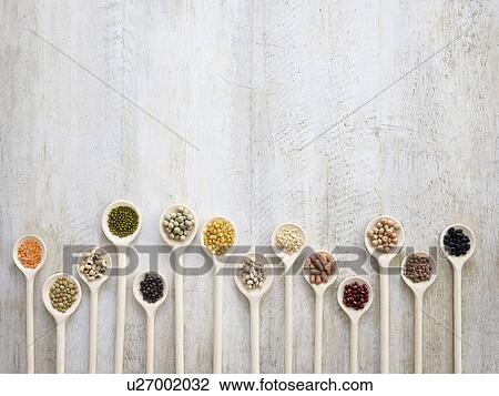 Stock Image - Pulses on wooden spoons. Fotosearch
