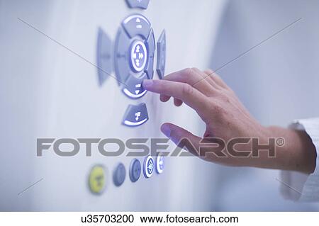 Radiologist operating CT scanner View Large Photo Image Stock Image - Radiologist operating CT scanner. Fotosearch