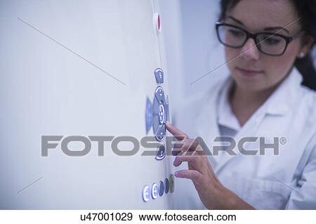 Stock Photo - Radiologist operating CT scanner. Fotosearch