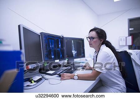 Radiologist studying scans View Large Photo Image Stock Image - Radiologist studying scans. Fotosearch