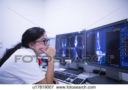 Radiologist studying scans View Large Photo Image Stock Photo - Radiologist studying scans. Fotosearch