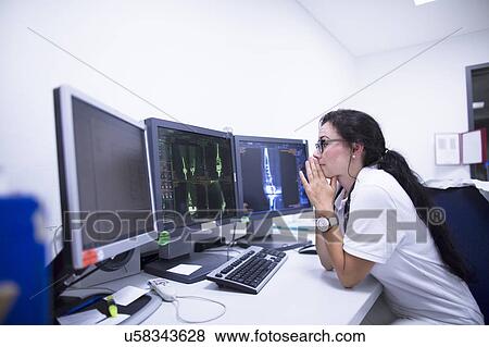 Stock Photo - Radiologist studying scans. Fotosearch