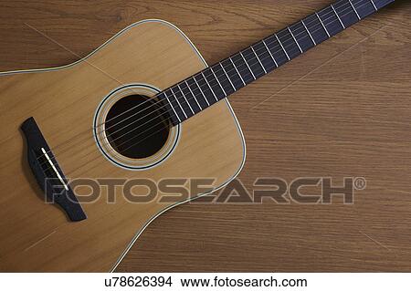 Picture - Acoustic guitar lying on floor. Fotosearch