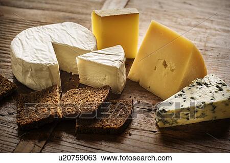 Stock Image - Assorted cheeses and bread slices. Fotosearch