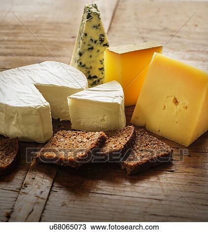 Assorted cheeses and bread slices View Large Photo Image Stock Image - Assorted cheeses and bread slices. Fotosearch