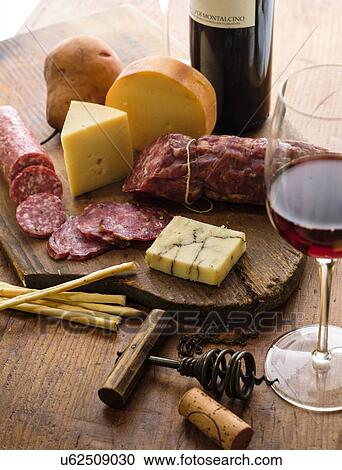 Assorted cheeses with salami and red wine View Large Photo Image Stock Image - Assorted cheeses with salami and red wine. Fotosearch