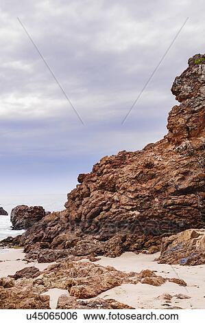 Australia, New South Wales, Rock formation on sandy beach View Large Photo Image Stock Photograph - Australia, New South Wales, Rock formation on sandy beach. Fotosearch