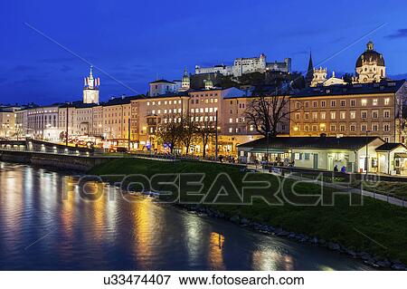 Austria, Salzburg, Illuminated townhouses in riverbank View Large Photo Image Stock Photo - Austria, Salzburg, Illuminated townhouses in riverbank. Fotosearch
