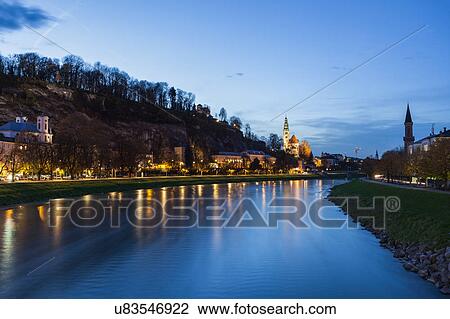 Austria, Salzburg, River and illuminated riverbank at dusk View Large Photo Image Stock Image - Austria, Salzburg, River and illuminated riverbank at dusk. Fotosearch