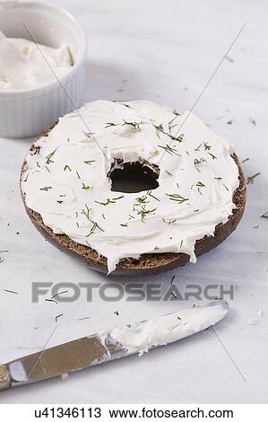 Bagel with cream cheese and dill View Large Photo Image Stock Image - Bagel with cream cheese and dill. Fotosearch