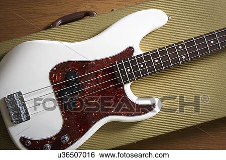Stock Photograph - Bass guitar lying on guitar case. Fotosearch