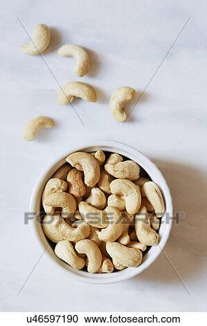 Bowl of cashews on white background View Large Photo Image Stock Image - Bowl of cashews on white background. Fotosearch