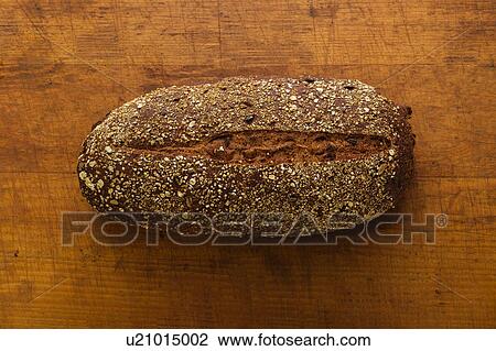 Stock Image - Bread on wooden table. Fotosearch