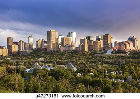 Stock Image - Canada, Alberta, Edmonton, Cityscape with trees in foreground. Fotosearch