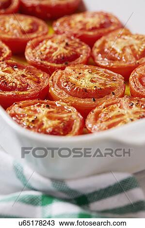 Stock Image - Cooked tomatoes in olive oil. Fotosearch