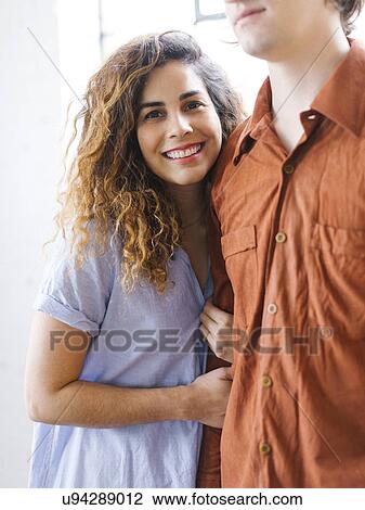 Couple standing against window View Large Photo Image Stock Image - Couple standing against window. Fotosearch