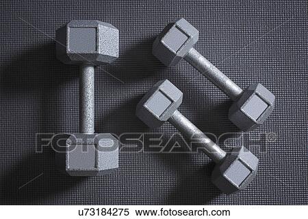 Stock Photography - Dumbbells on grey background. Fotosearch
