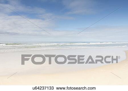 Stock Image - Empty beach on sunny day. Fotosearch