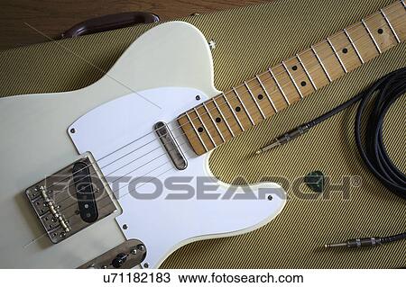 Stock Image - Fender Telecaster and music equipment lying on guitar case. Fotosearch