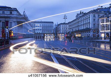 Stock Photograph - France, Nouvelle-Aquitaine, Bordeaux, City street at dusk. Fotosearch
