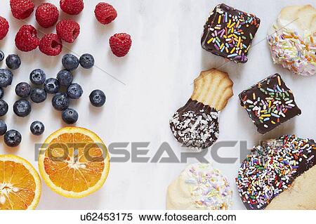 Fruits versus cookies View Large Photo Image Stock Photography - Fruits versus cookies. Fotosearch