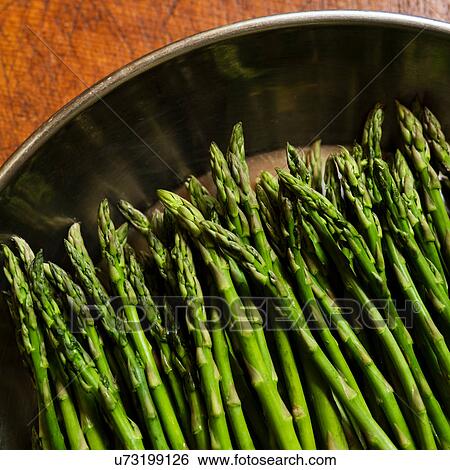 Stock Photograph - Green asparagus in metal pot. Fotosearch