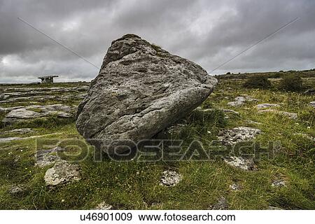 Stock Photo - Ireland, Clare County, Burren, Big stone with Poulnabrone Dolmen in background. Fotosearch