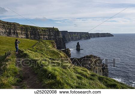 Ireland, Clare County, Woman looking at view on Cliffs of Moher View Large Photo Image Stock Photo - Ireland, Clare County, Woman looking at view on Cliffs of Moher. Fotosearch