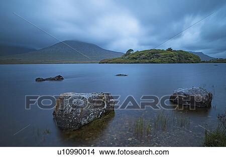 Picture - Ireland, Galway County, Connemara, Stones in lake. Fotosearch