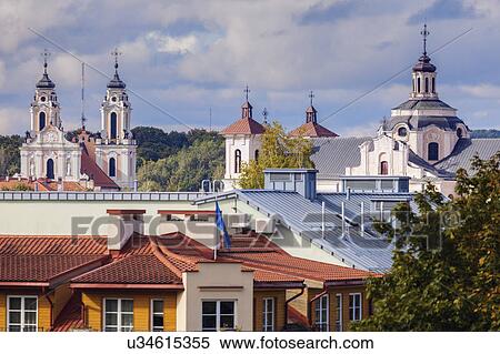 Stock Photography - Lithuania, Vilnius, Residential building with churches in background. Fotosearch