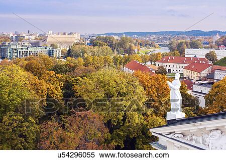 Lithuania, Vilnius, Statue on roof with cityscape in background View Large Photo Image Stock Photography - Lithuania, Vilnius, Statue on roof with cityscape in background. Fotosearch