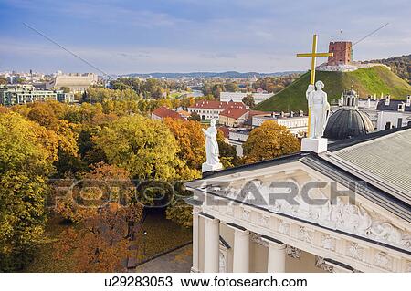 Stock Image - Lithuania, Vilnius, Vilnius cathedral roof with cityscape in background. Fotosearch