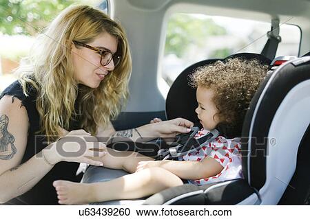 Mother and daughter (12-17 months) in car View Large Photo Image Stock Image - Mother and daughter (12-17 months) in car. Fotosearch