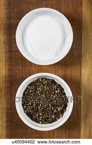 Stock Image - Ramekins with salt and pepper. Fotosearch