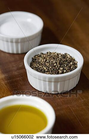 Stock Image - Ramekins with salt, pepper and olive oil. Fotosearch