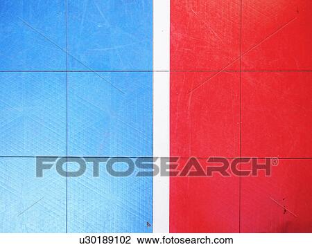 Stock Image - Red and blue tiled floor of basketball court. Fotosearch
