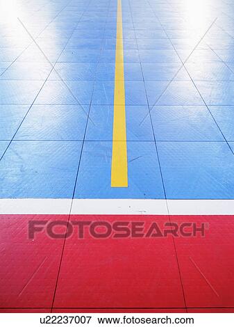 Stock Photo - Red and blue tiled floor of basketball court. Fotosearch