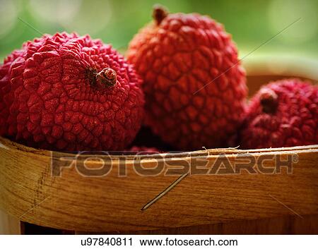 Stock Image - Red lychee in basket. Fotosearch