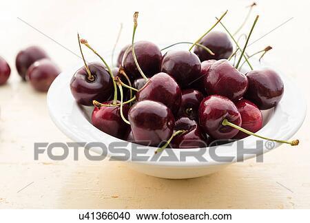 Ripe cherries in white bowl on table View Large Photo Image Stock Image - Ripe cherries in white bowl on table. Fotosearch