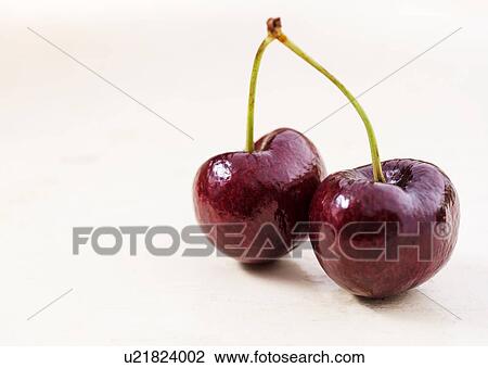Stock Image - Shiny cherries on white background. Fotosearch