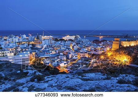 Stock Image - Spain, Andalusia, Almeria, Cityscape with sea at dusk. Fotosearch