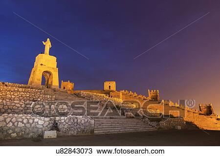 Stock Image - Spain, Andalusia, Almeria, Statue of Sacred Heart of Jesus at dusk. Fotosearch
