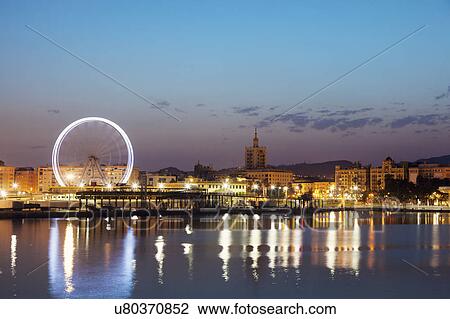 Stock Image - Spain, Seville, Andalusia, Waterfront at dusk. Fotosearch