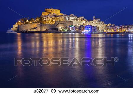 Spain, Valencian Community, Peniscola, Waterfront at night View Large Photo Image Stock Photo - Spain, Valencian Community, Peniscola, Waterfront at night. Fotosearch