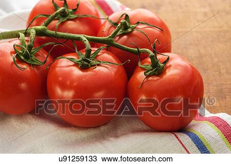 Stock Image - Tomatoes on table. Fotosearch