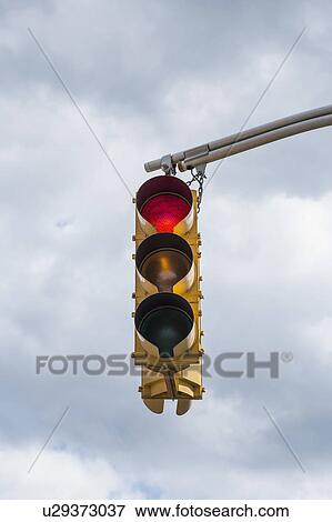 Stock Photo - Traffic light against storm clouds. Fotosearch