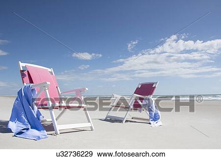 Two deckchairs on empty beach View Large Photo Image Stock Photo - Two deckchairs on empty beach. Fotosearch